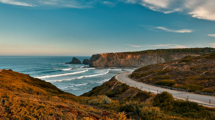 Panoramic view of the rugged cliffs and Atlantic waves along Costa Vicentina, part of the Southwest Alentejo and Vicentine Coast Natural Park in Portugal.