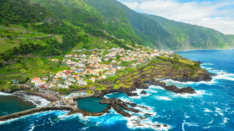 Panoramic view of Seixal village on Madeira Island with green cliffs, blue Atlantic waters, and scenic coastline.