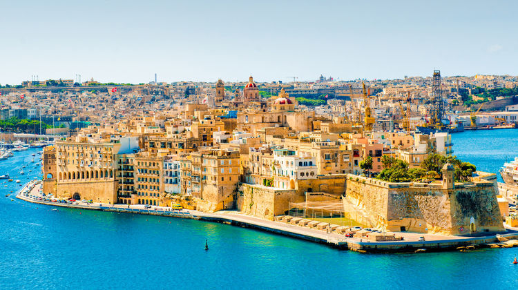 Panoramic view of Valletta, Malta, showcasing the fortified city walls, Grand Harbour, and historic limestone buildings. The UNESCO World Heritage capital is one of the Mediterranean's best-preserved fortified cities.