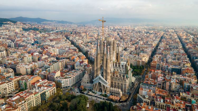 Drone view of La Sagrada Família basilica standing tall amid the urban grid of Barcelona, Spain