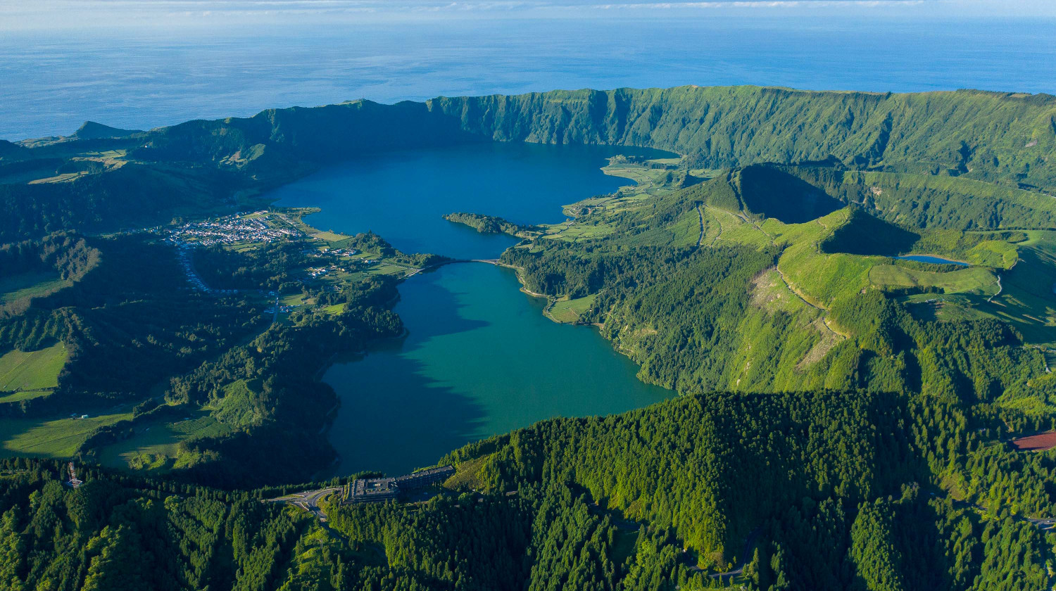 Aerial view of Sete Cidades Lake surrounded by volcanic crater walls in São Miguel, Azores