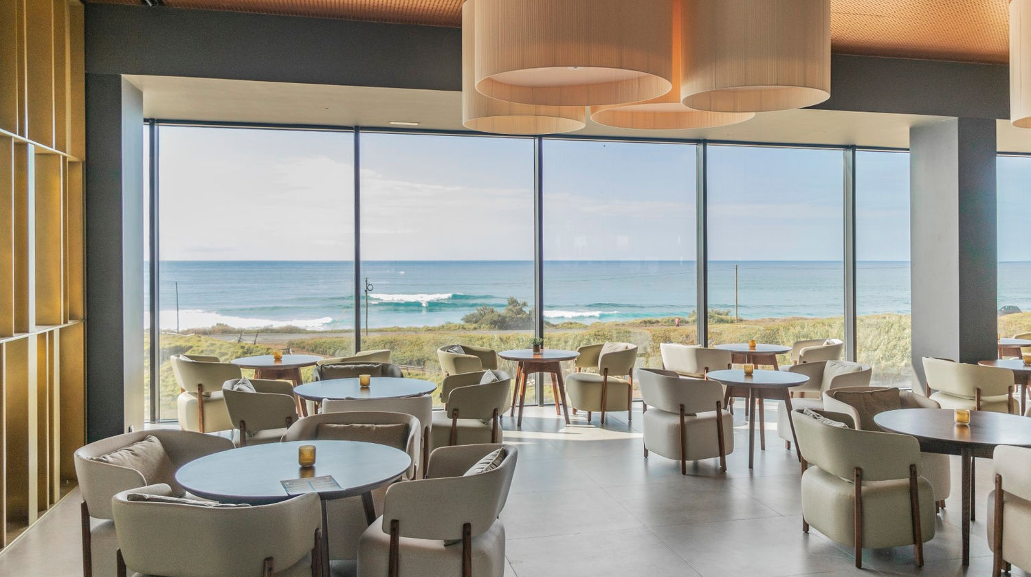 Dining room at Hotel Verde Mar & Spa featuring floor-to-ceiling windows with views of the Atlantic Ocean on São Miguel Island.