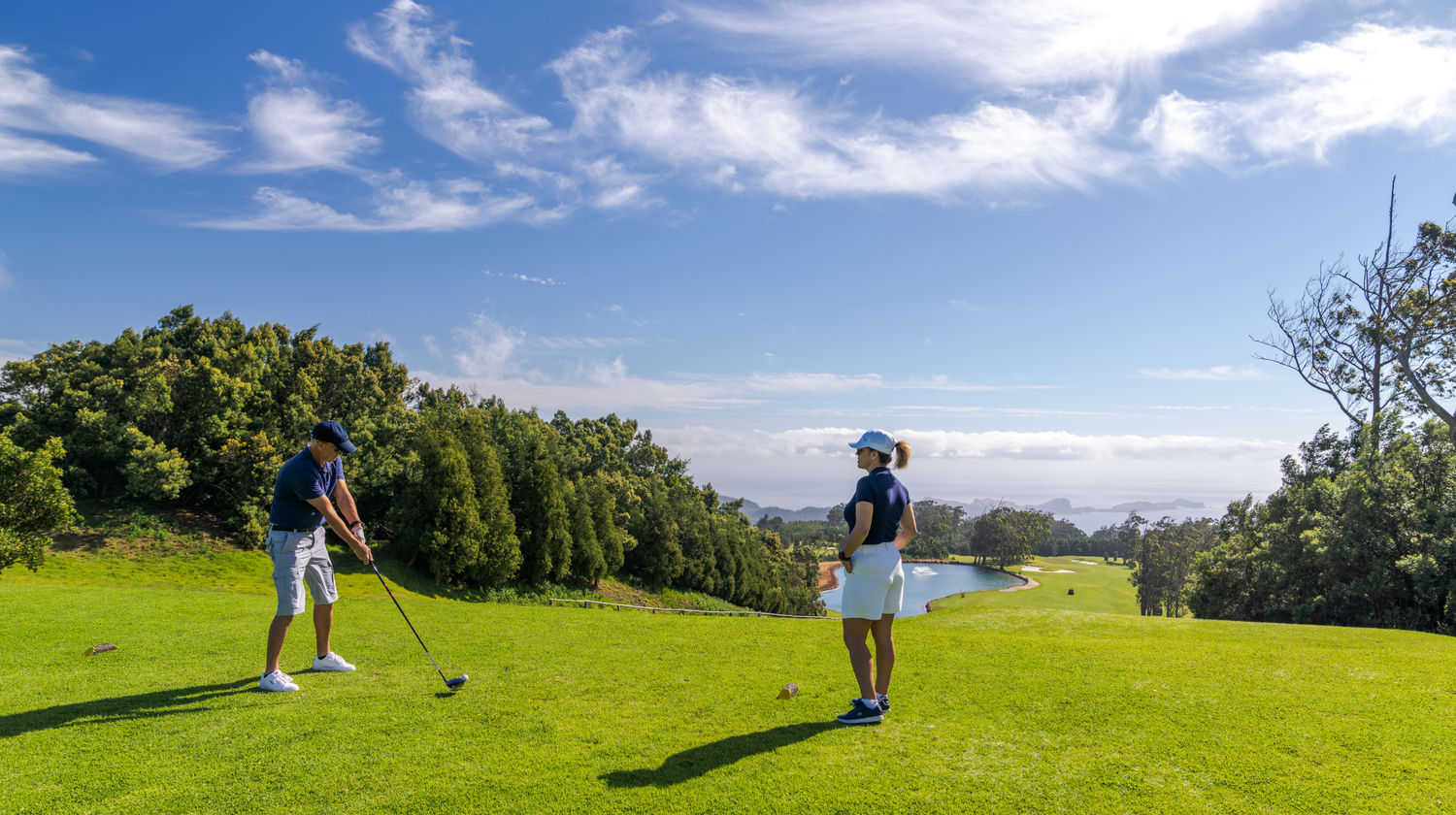 Golfers preparing to tee off at Santo da Serra Golf Course with ocean views in Madeira Island