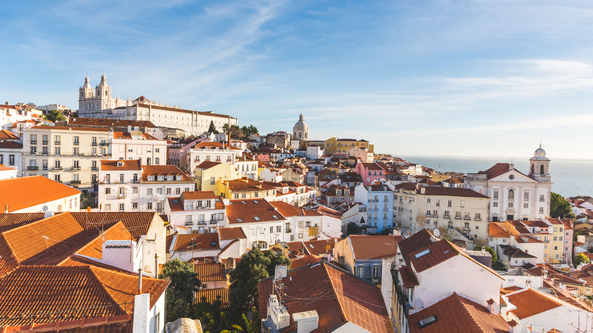 Rooftop view over Lisbon’s terracotta rooftops and whitewashed buildings