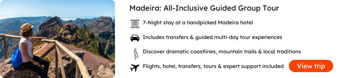 Madeira All-Inclusive Guided Group Tour – 7 Nights with Flights, Hotel & Tours Traveler enjoying mountain views on a guided group tour in Madeira, Portugal, with dramatic peaks and hiking trails in the background.