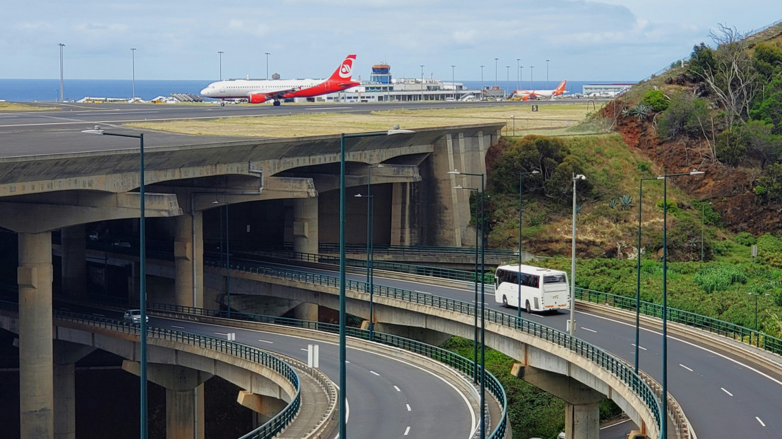 View of Madeira Cristiano Ronaldo Airport in Santa Cruz, Portugal, showing aircraft on the runway and the elevated road network below. The image highlights the airport&rsquo;s coastal setting and distinctive infrastructure on Madeira Island.
