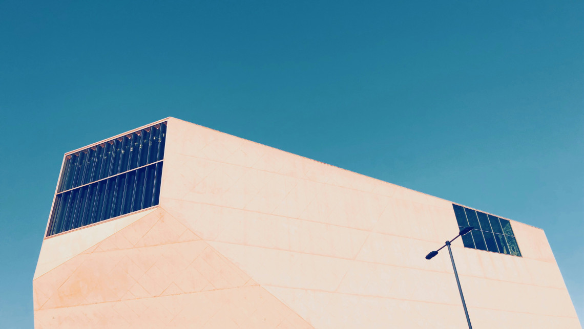 Exterior view of Casa da M&uacute;sica in Porto, Portugal, showing the concert hall&rsquo;s angular modern architecture against a clear blue sky. The image highlights one of Porto&rsquo;s key cultural landmarks.