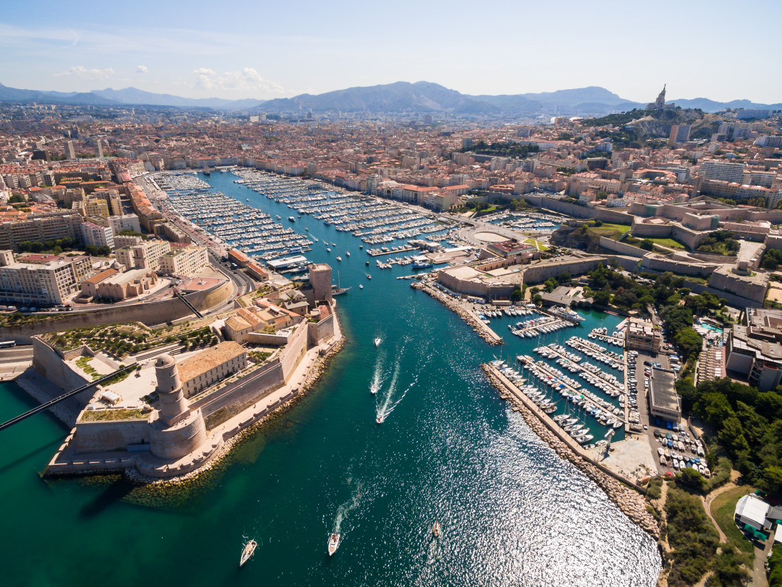 Aerial view of Marseille&rsquo;s Vieux-Port in southern France, with hundreds of boats in the marina, Fort Saint-Jean at the harbour entrance and the city extending toward the surrounding hills.