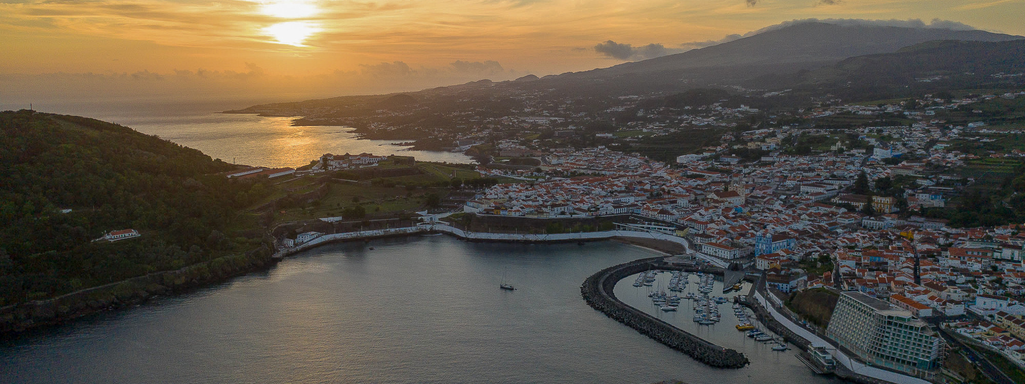 Aerial view of Angra do Heroísmo at sunset, with the historic UNESCO World Heritage city centre, harbour, and Monte Brasil visible, Terceira Island, Azores