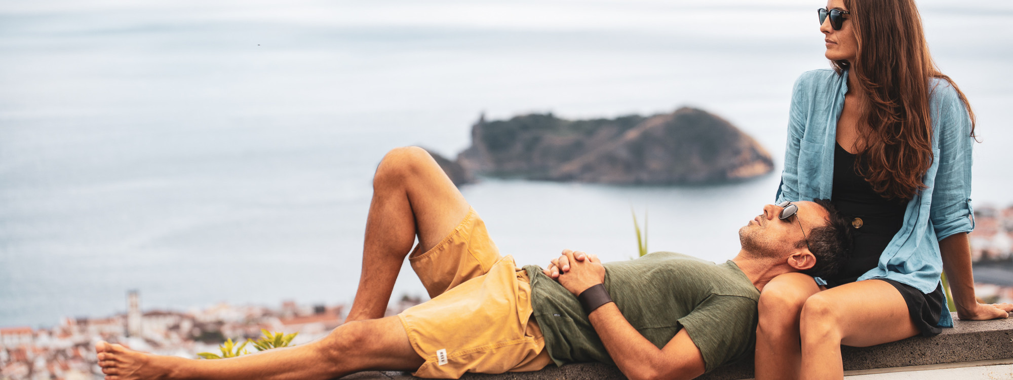 Couple relaxing with views of the Ilhéu de Vila Franca do Campo on São Miguel Island, Azores