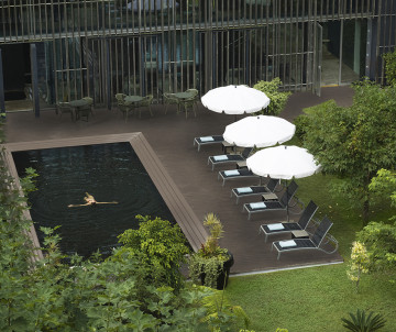 Outdoor pool at Octant Furnas hotel surrounded by lush gardens in São Miguel Island, Azores