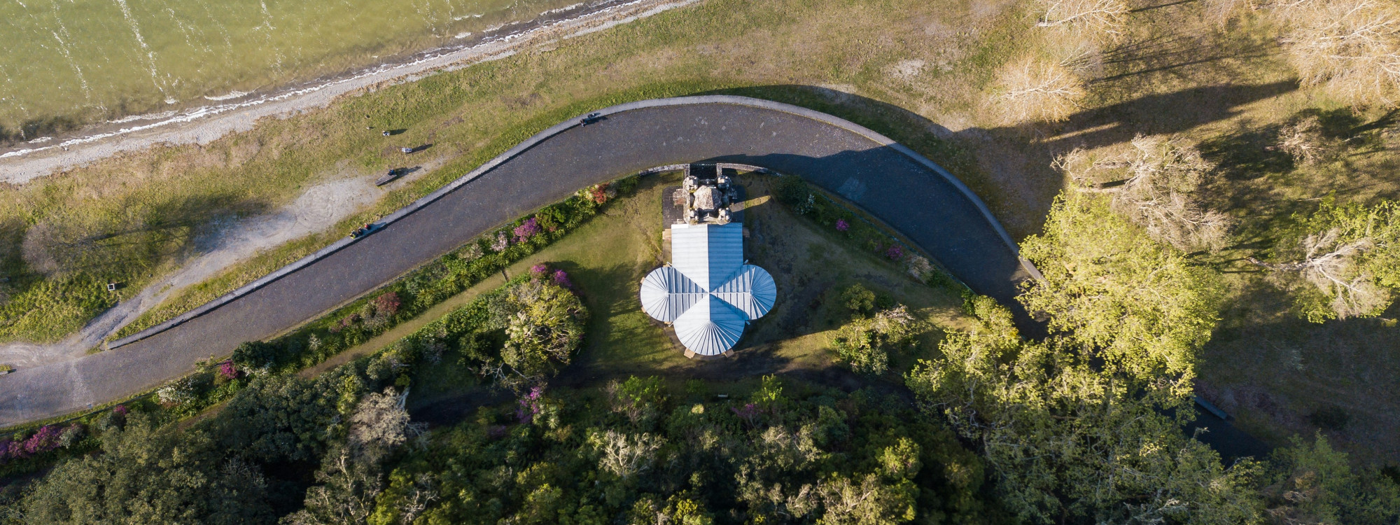 Aerial view of Capela de Nossa Senhora das Vitórias in Furnas, São Miguel Island, Azores, Portugal. The Neo-Gothic chapel is surrounded by gardens and trees beside Lagoa das Furnas, creating one of the island's most iconic cultural landscapes.