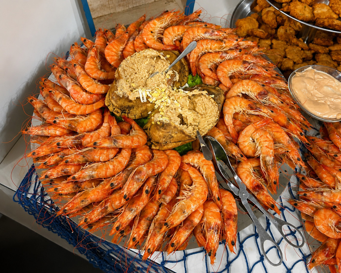 Traditional seafood platter served at Aroma das Ilhas Restaurante on S&atilde;o Miguel Island, Azores, Portugal. Fresh Atlantic prawns and regional specialties showcase the island's rich seafood and culinary traditions.