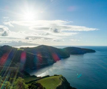 Panoramic view from Miradouro de Santa Iria on São Miguel Island, Azores, Portugal. The viewpoint overlooks dramatic volcanic cliffs, the Atlantic Ocean, and the island's rugged northern coastline.