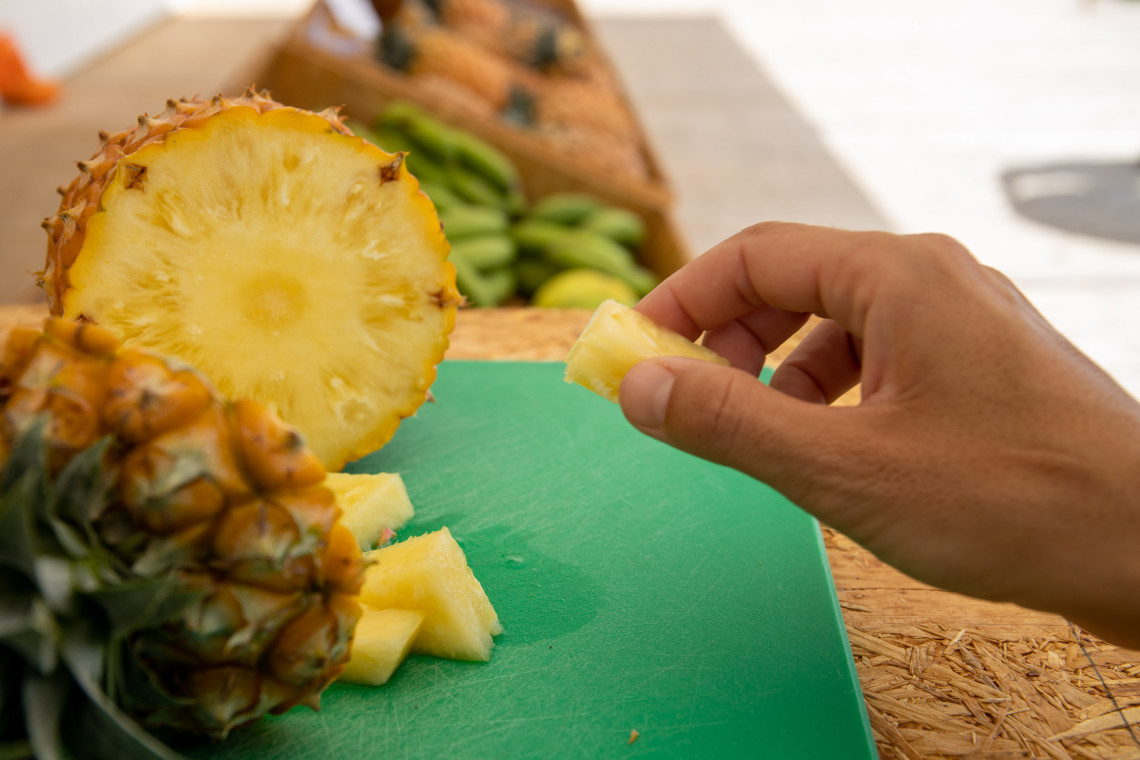 Freshly sliced Anan&aacute;s dos A&ccedil;ores being tasted at a pineapple plantation in Ponta Delgada on S&atilde;o Miguel Island.