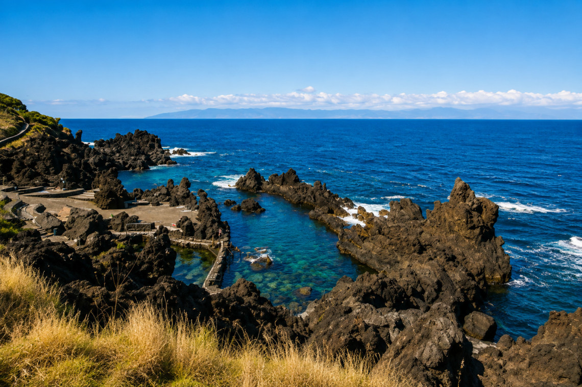 Po&ccedil;as de S&atilde;o Roque natural swimming pools on Pico Island, formed among rugged black volcanic rocks beside the Atlantic Ocean. Clear water fills sheltered natural basins along the coast.