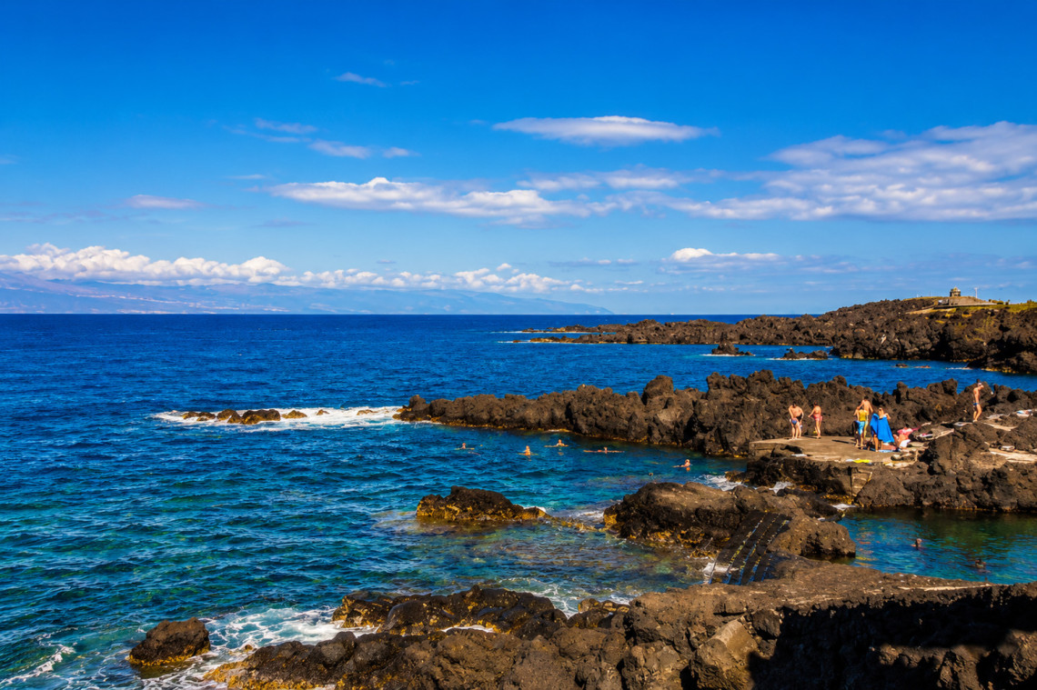 Piscina Natural do Cais do Pico in S&atilde;o Roque do Pico, where swimmers use sheltered Atlantic pools formed between black volcanic rocks along the waterfront.