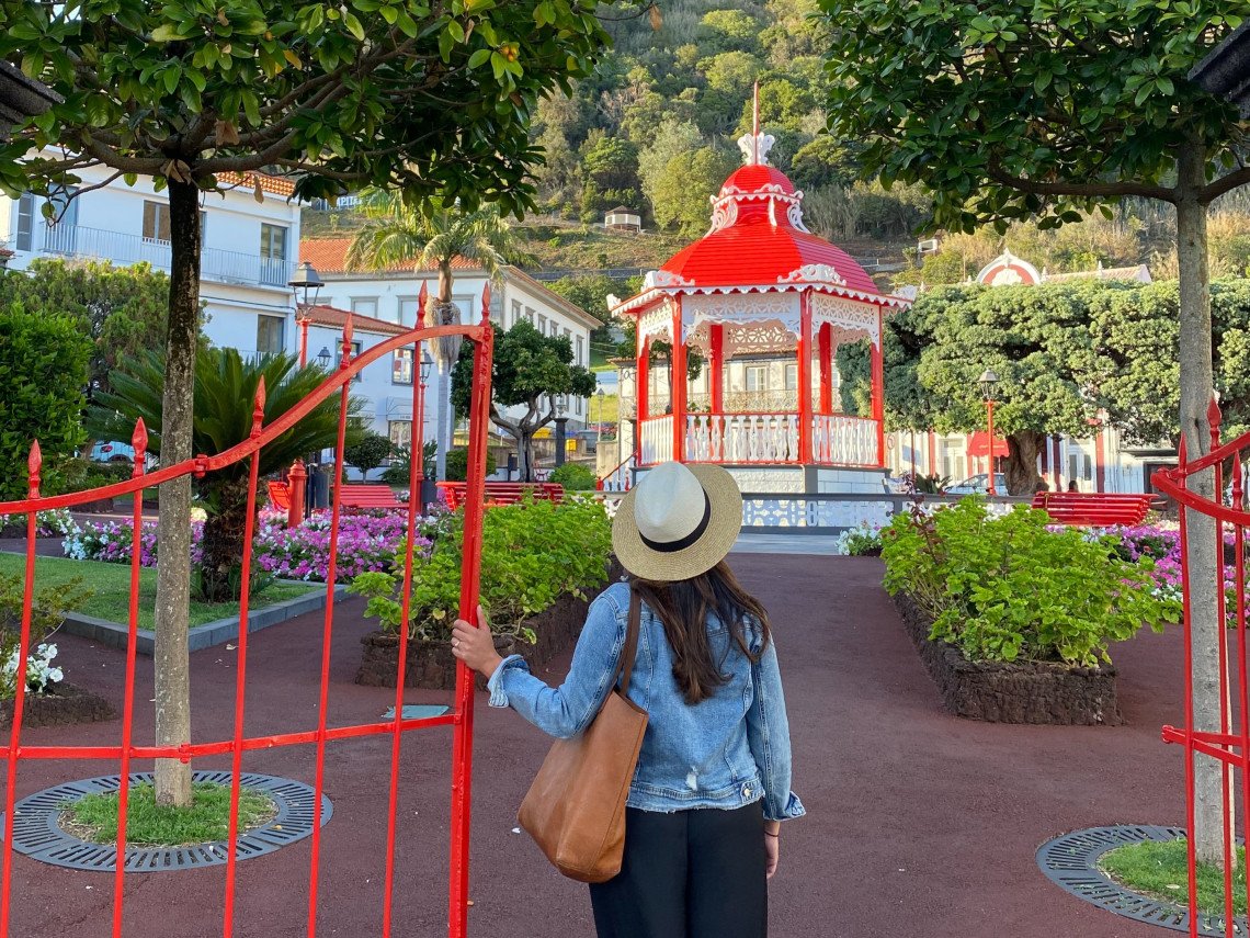 Traveler entering Jardim da Rep&uacute;blica in Velas, S&atilde;o Jorge, with its distinctive red and white bandstand, flower beds and landscaped paths.