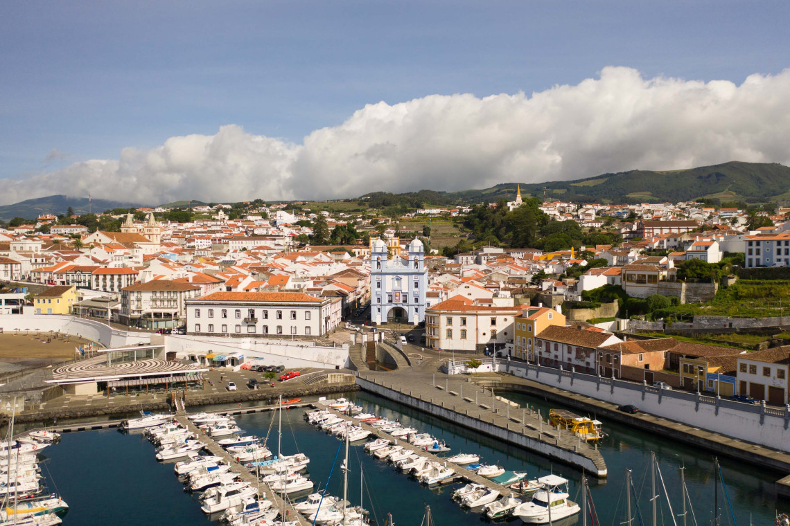View across Angra do Hero&iacute;smo Marina toward the historic waterfront and the blue-and-white Igreja da Miseric&oacute;rdia on Terceira Island.