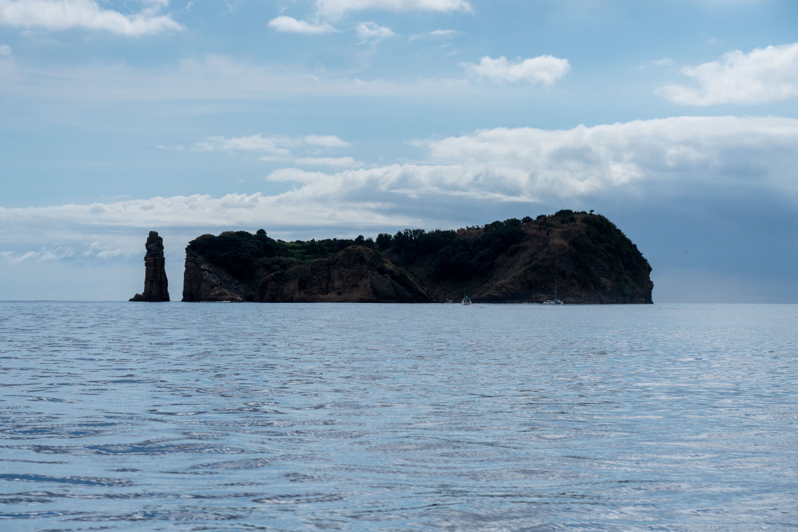 Sea-level view of Vila Franca Islet off S&atilde;o Miguel Island, showing its vegetation-covered volcanic slopes and distinctive rocky sea stack above the Atlantic.