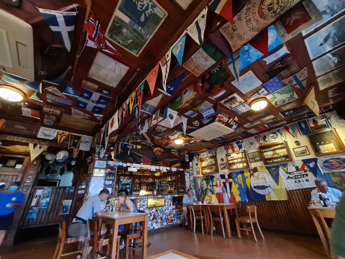 Interior of Peter Caf&eacute; Sport in Horta, with yacht flags, maritime memorabilia and wooden furnishings reflecting the caf&eacute;&rsquo;s long connection with Atlantic sailors.