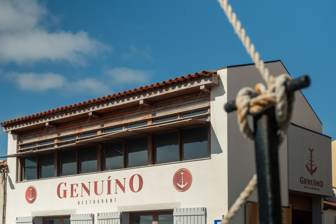 Exterior of Genu&iacute;no Restaurant in Horta on Faial Island, located near Porto Pim and distinguished by its nautical-inspired signage.
