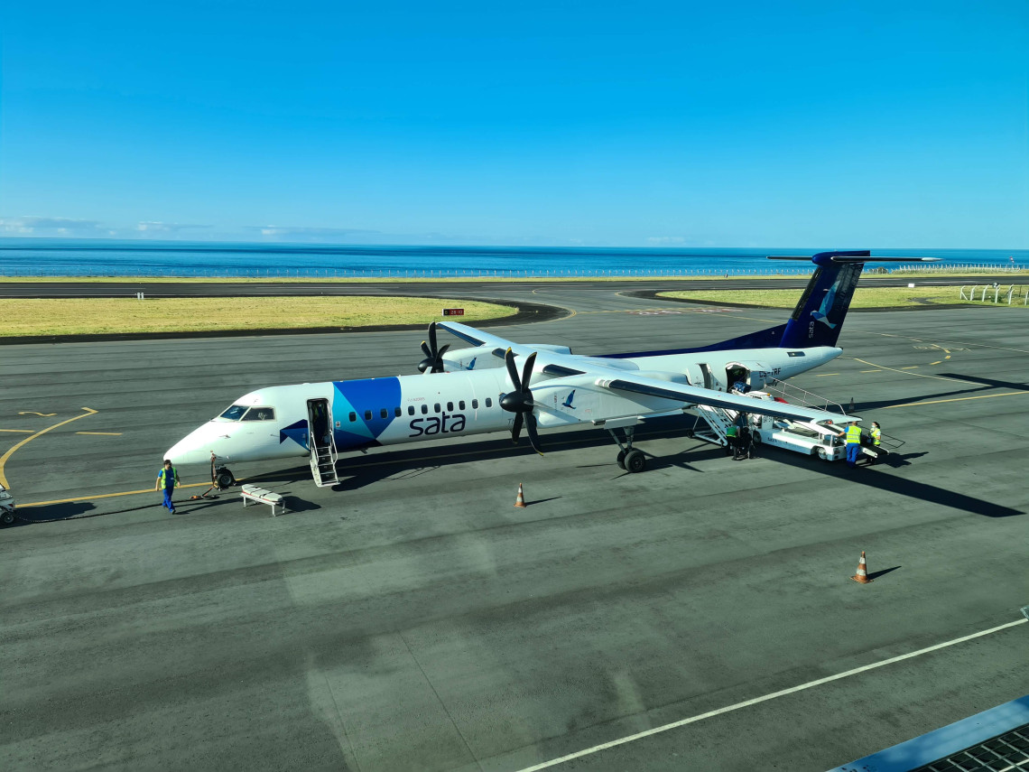 A SATA Air A&ccedil;ores turboprop aircraft stands on the apron at Horta Airport on Faial Island in the Azores, Portugal. The airport runway lies beside the Atlantic Ocean on the island&rsquo;s southern coast.