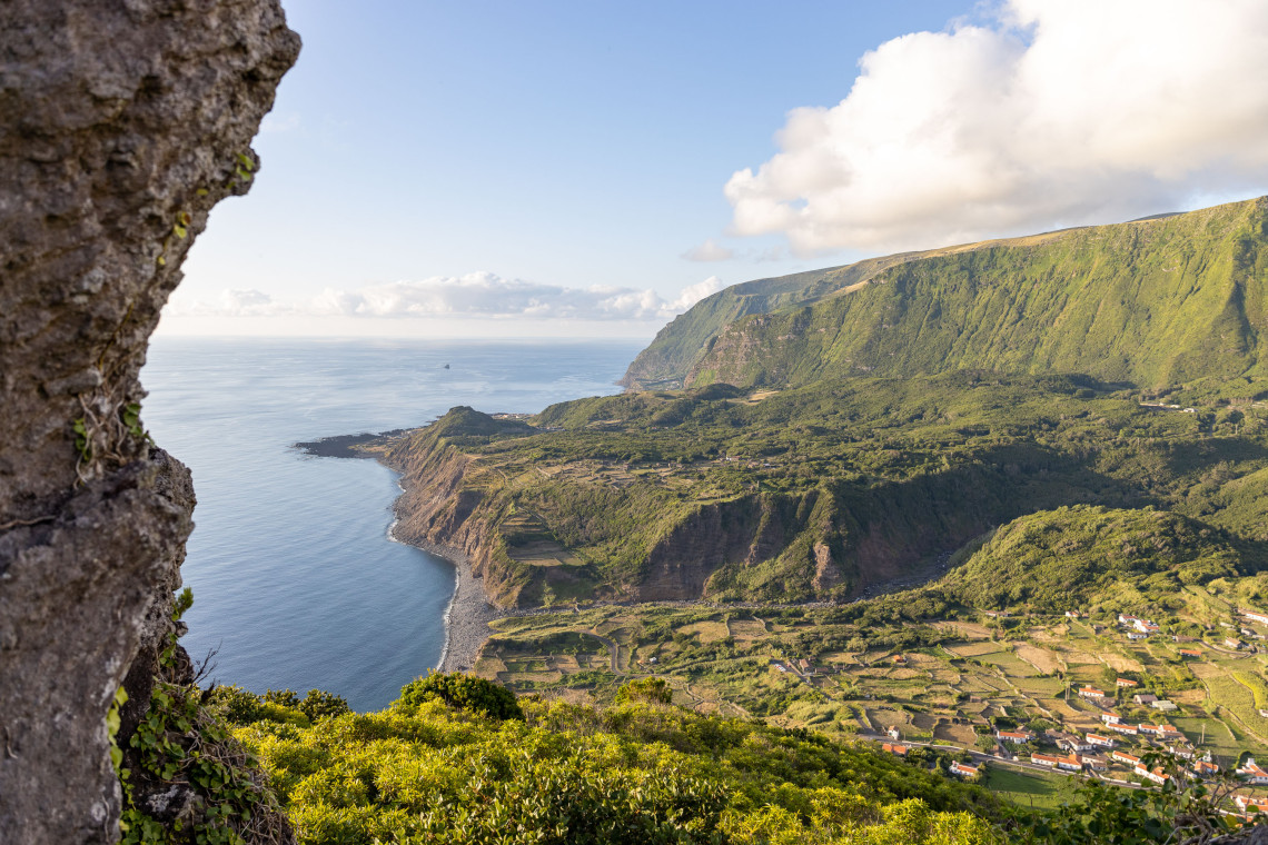 Elevated view over Faj&atilde; Grande on the west coast of Flores Island in the Azores, Portugal. Patchwork fields lie between the Atlantic Ocean and the high green cliffs of Rocha da Faj&atilde;.