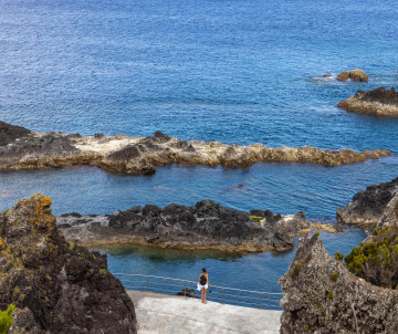 Natural swimming pools in Santa Cruz das Flores on Flores Island, Azores, Portugal. Volcanic rock formations create sheltered ocean pools overlooking the Atlantic coastline.