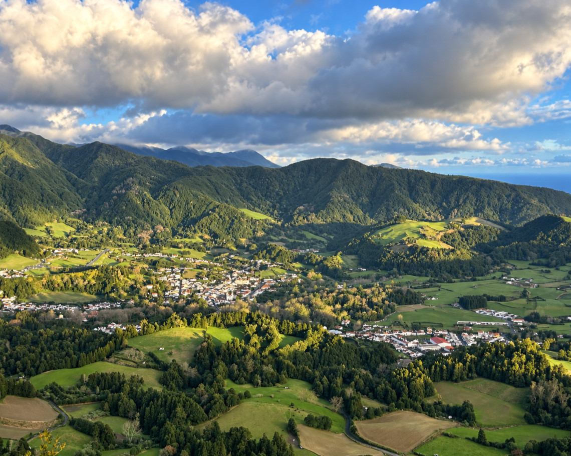 Panoramic view over Furnas village on S&atilde;o Miguel Island, surrounded by green pastures, dense forests and the mountainous volcanic landscape of the Furnas caldera.