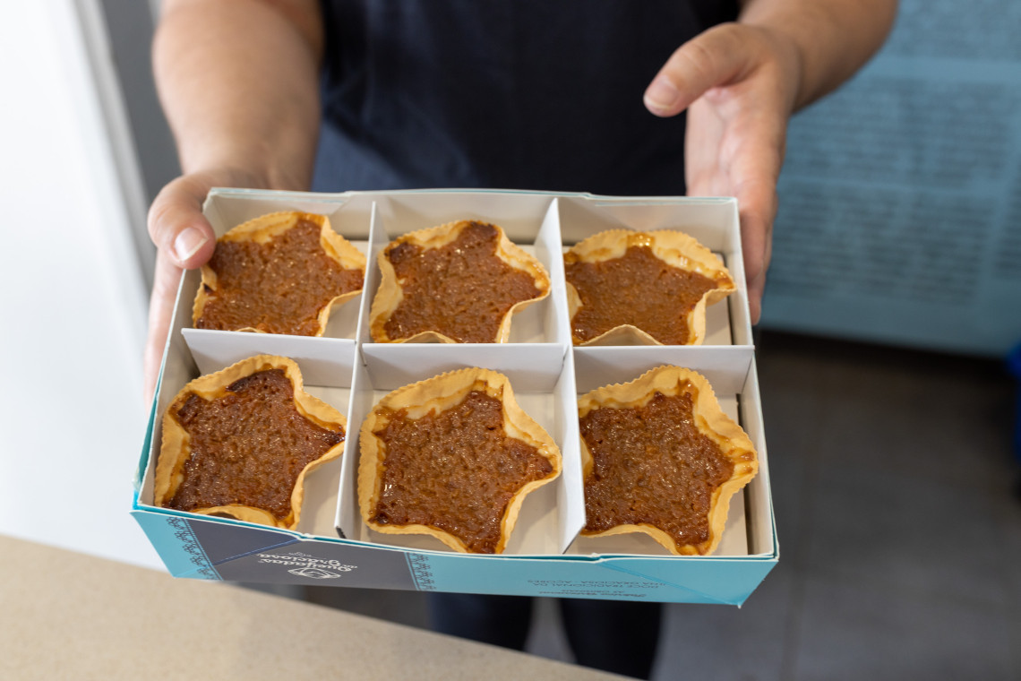 Box of Queijadas da Graciosa, traditional star-shaped pastries from Graciosa Island with thin pastry shells and a sweet brown filling.