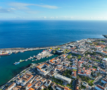 Aerial view of Ponta Delgada on São Miguel Island, showing the historic city center, harbor and waterfront beside the Atlantic Ocean.