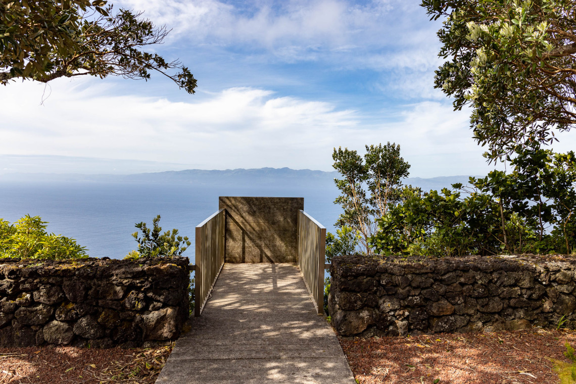 Wooden viewing platform at Terra Alta Viewpoint overlooking the Atlantic Ocean and S&atilde;o Jorge Island from the northern cliffs of Pico Island.