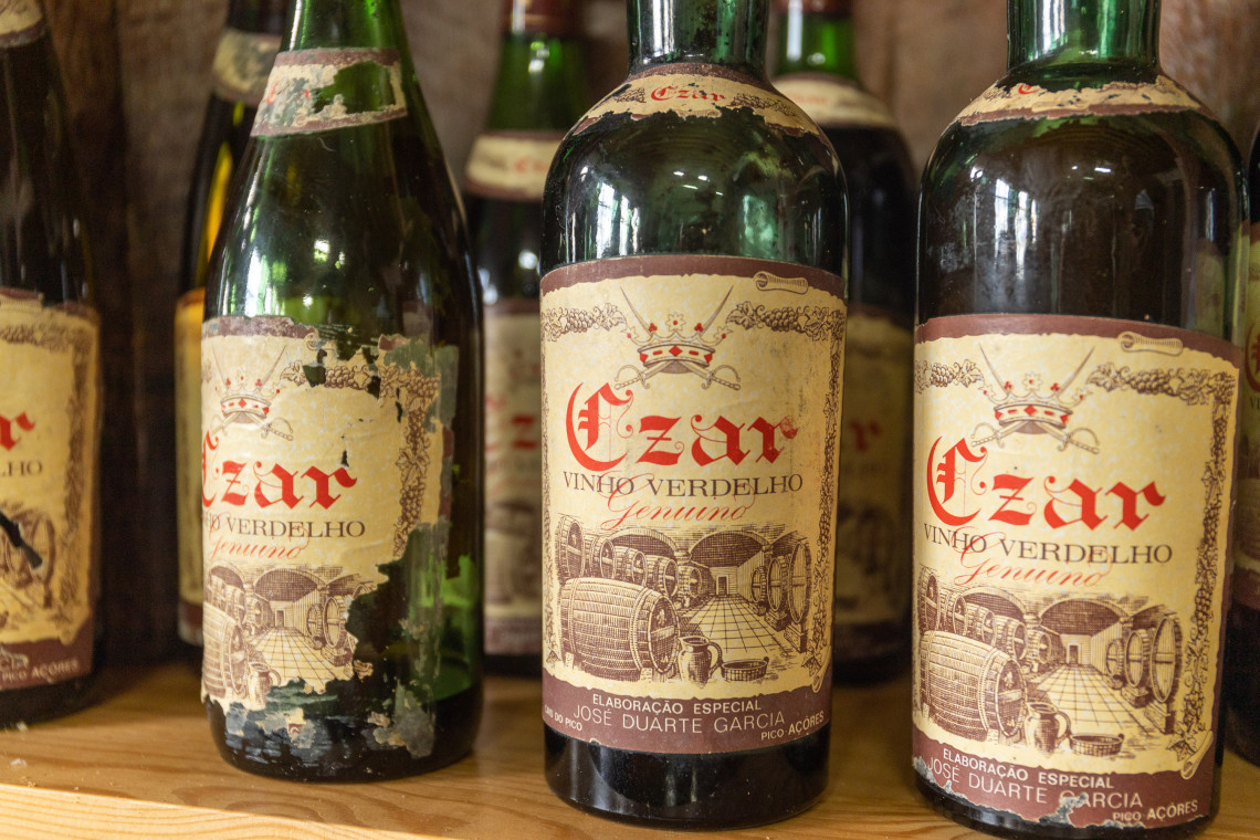 Historic bottles of Verdelho wine displayed at the Museu do Vinho in Madalena, representing Pico Island’s long winemaking tradition.