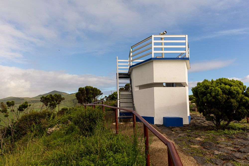 White whale lookout building at Ponta dos Rosais on S&atilde;o Jorge Island, with an elevated observation platform surrounded by Atlantic coastal vegetation.