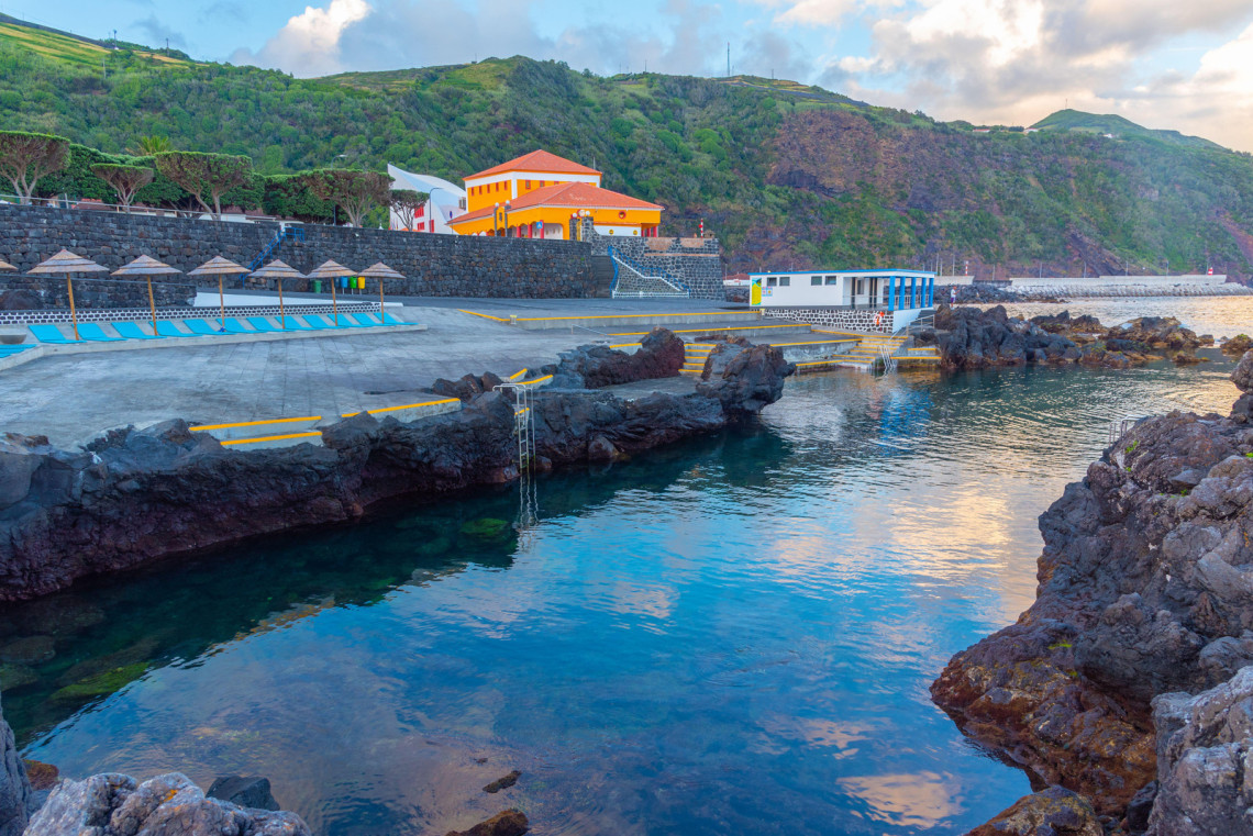 Natural seawater swimming area built into the volcanic coastline of S&atilde;o Jorge Island, with basalt rocks, bathing platforms and coastal facilities.