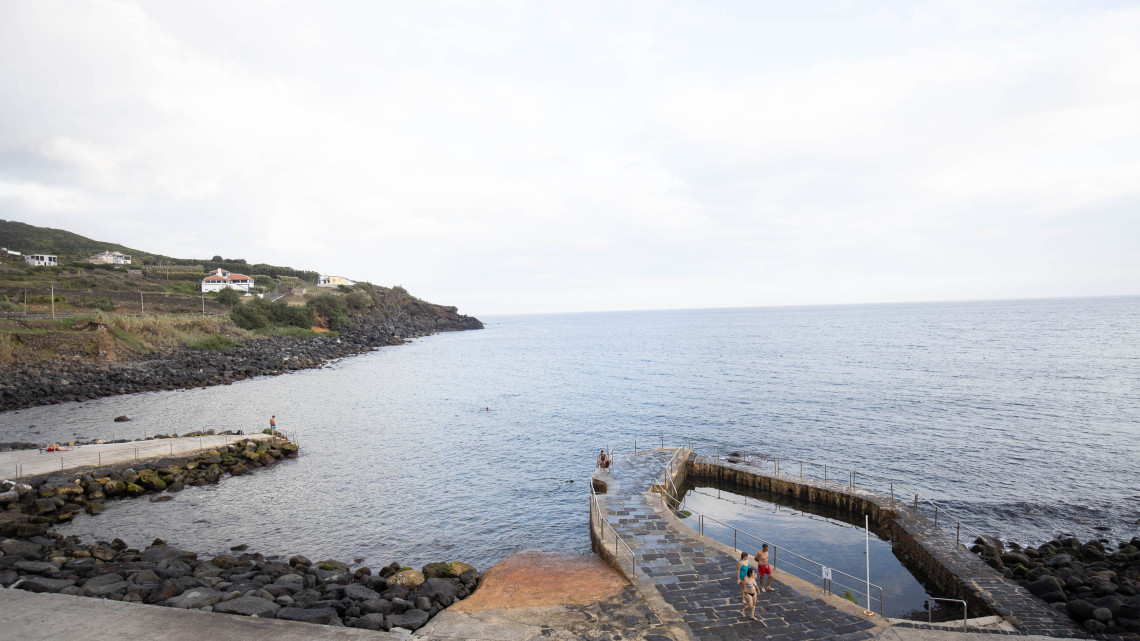 Coastal swimming area at Salga on Terceira Island, with a sheltered seawater pool, concrete access platforms and the rocky Atlantic shoreline.