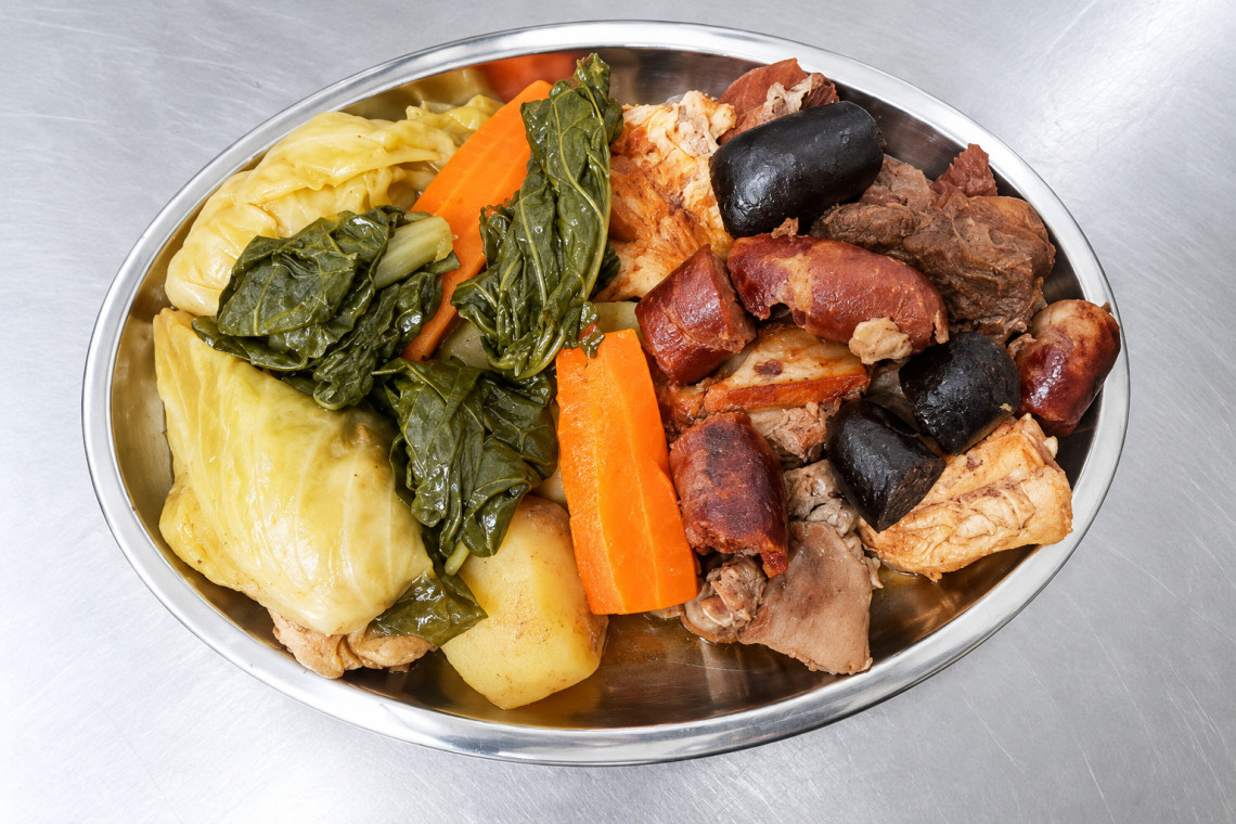 Traditional Cozido das Furnas served with cabbage, potatoes, carrots and a selection of meats and sausages. The dish is one of S&atilde;o Miguel&rsquo;s best-known culinary traditions.