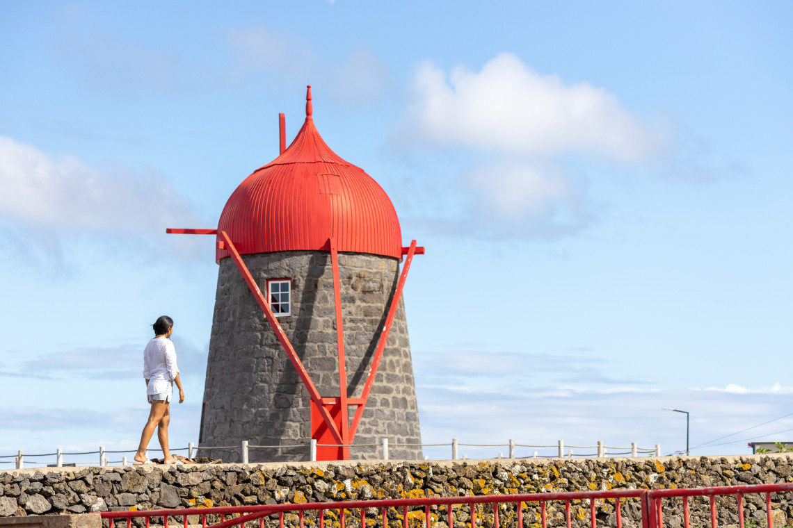 Traditional stone windmill on Graciosa Island with the distinctive red wooden cap associated with the island&rsquo;s historic grain-milling heritage. Red-roofed tower windmills are a characteristic feature of Graciosa.