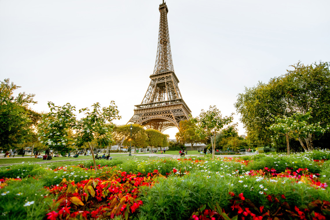 The Eiffel Tower illuminated against a blue sky in Paris, France