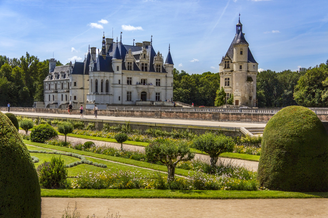 Ch&acirc;teau de Chenonceau spanning the Cher River in the Loire Valley, France, surrounded by autumn trees