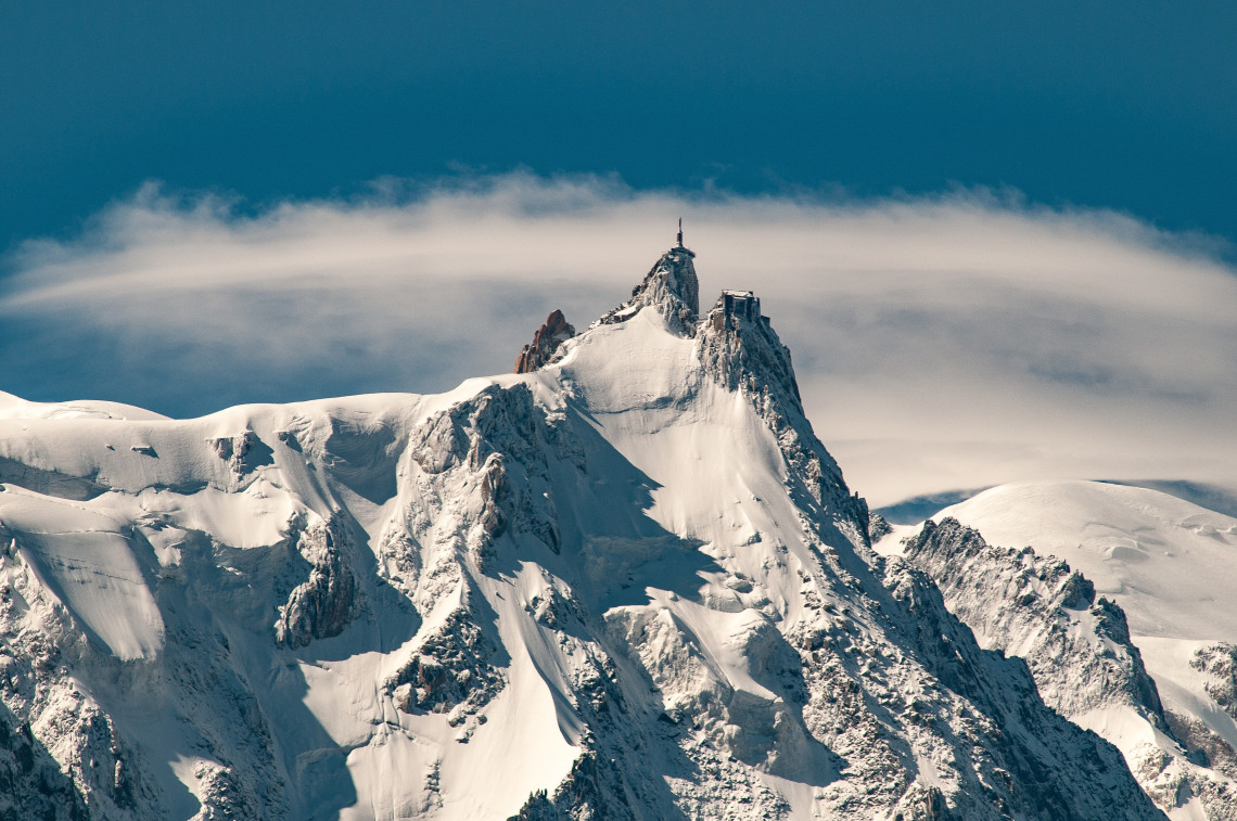 Aiguille du Midi peak above the clouds in the Mont Blanc massif near Chamonix, French Alps