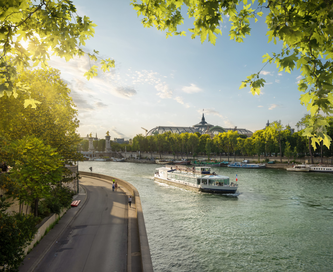 Golden dawn light over the Seine River in Paris with bridges and Haussmann buildings reflected on the water
