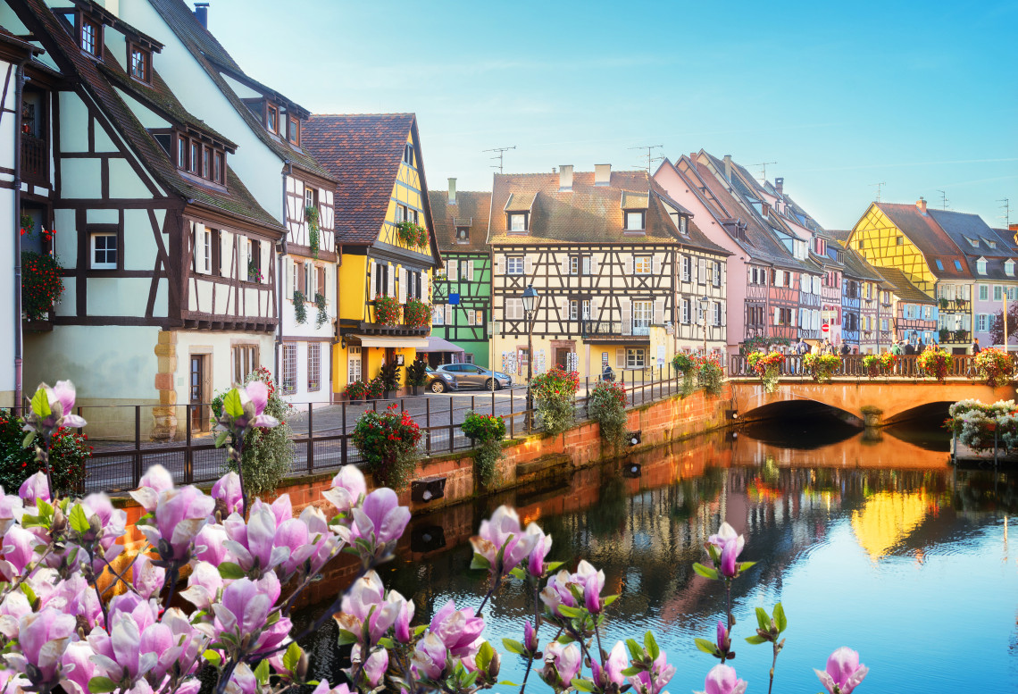 Half-timbered pastel houses lining the canal in the Petite Venise district of Colmar, Alsace, France