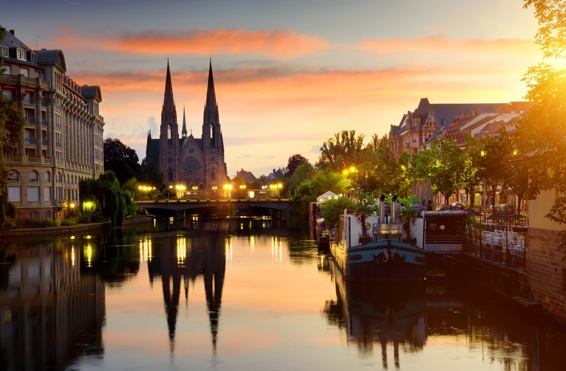 Gothic spire of Strasbourg Cathedral rising above the rooftops of the historic Grande &Icirc;le, Alsace, France