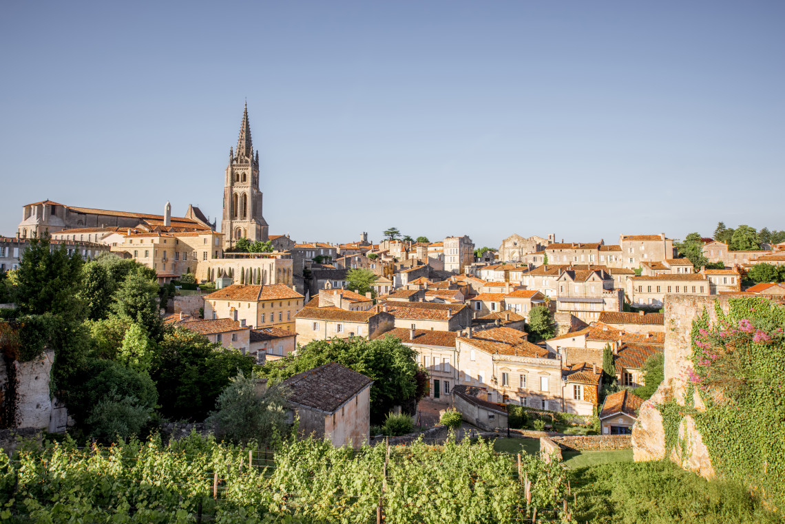 Medieval stone village of Saint-&Eacute;milion with vine-covered hillsides and church bell tower, Bordeaux, France