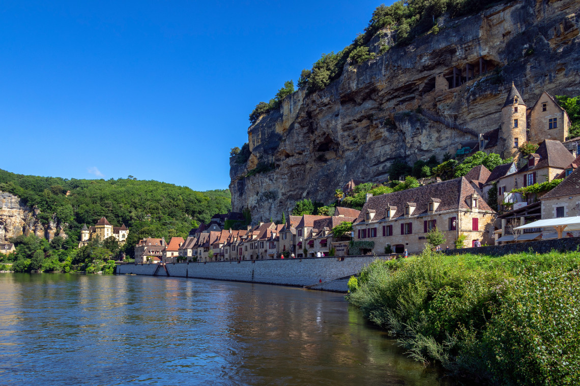 The medieval village of La Roque Gageac nestled between a dramatic limestone cliff and the Dordogne River in the P&eacute;rigord region of France