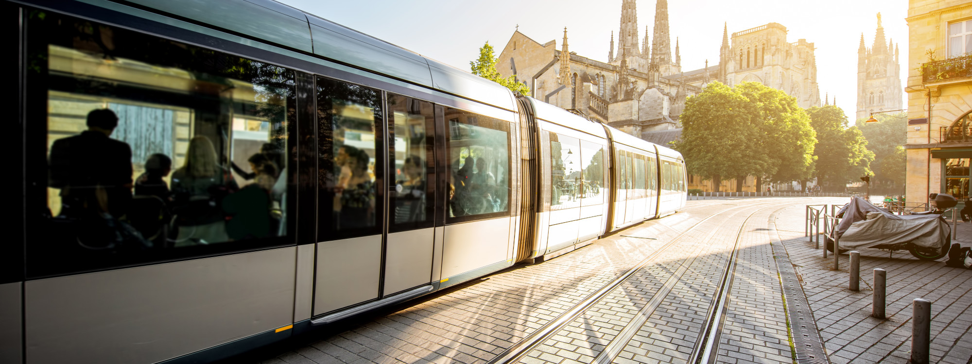 Modern tram passing in front of the Gothic Saint-Andre Cathedral in the city center of Bordeaux, France