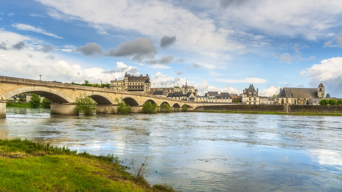 Stone bridge over the Loire River with Chateau d'Amboise and the town skyline in the background, Loire Valley, France