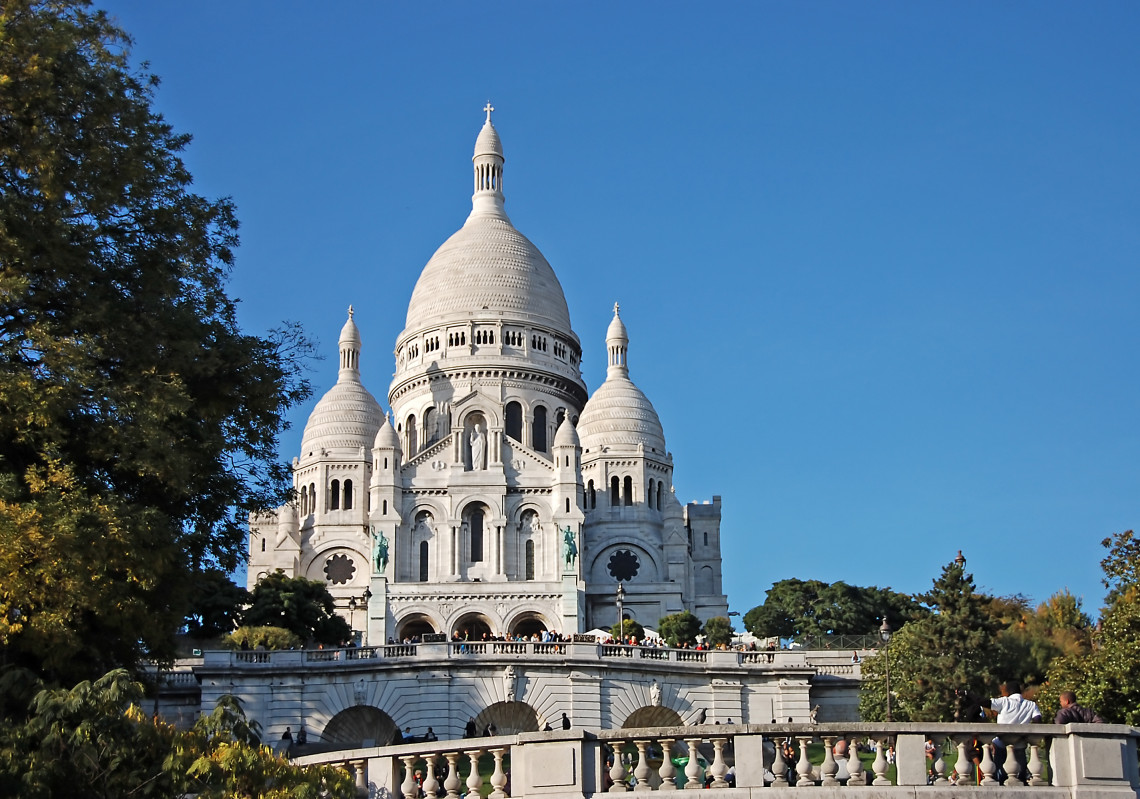 White domed Basilica of Sacre-Coeur on the hill of Montmartre under a clear blue sky, Paris, France